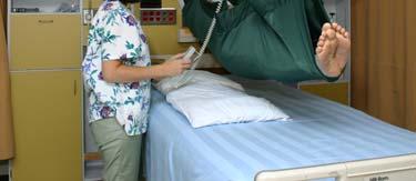 COMPLETE TRANSFER a) before lowering resident onto the bed, place pillow(s) lengthwise on the bed at trunk