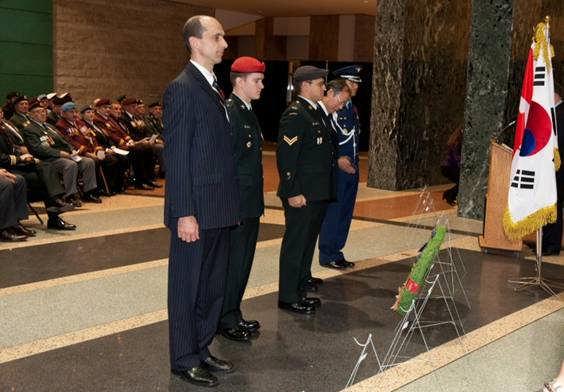 Honourable Steven Blaney, Minister of Veterans Affairs, and His Excellency Joo Hong Nam, the Ambassador for the Republic of Korea, place wreaths at the altar within the Ottawa City Hall, to