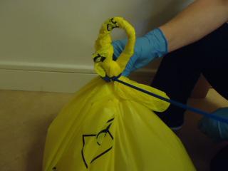 bags/bins away from your body & by the neck only Bags should not be decanted from one