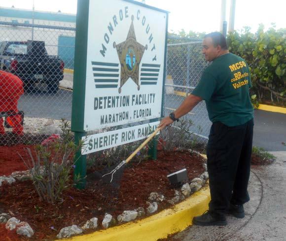 Sgt. Juan Morales and a team of inmates work on spiffing up the outside of the Marathon jail recently.