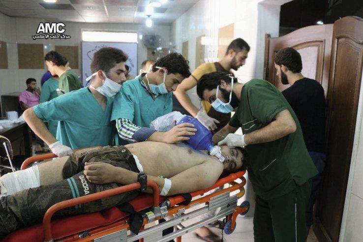 A photo taken on 6 Septempber 2016, provided by the Syrian anti-government activist group Aleppo Media Center (AMC), shows medical staff treating a man suffering from breathing difficulties inside a