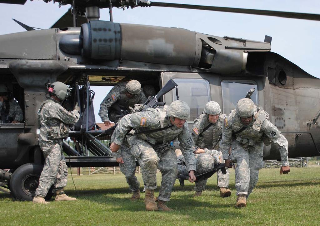 TRAINING AND EDUCATION Quartermaster second lieutenants unload a mock casualty from a UH 60 Black Hawk helicopter as part of the Basic Officer Leader Department field training exercise.