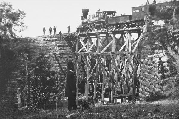 Soldiers guard a train on a Union Army-built trestle on the Orange and