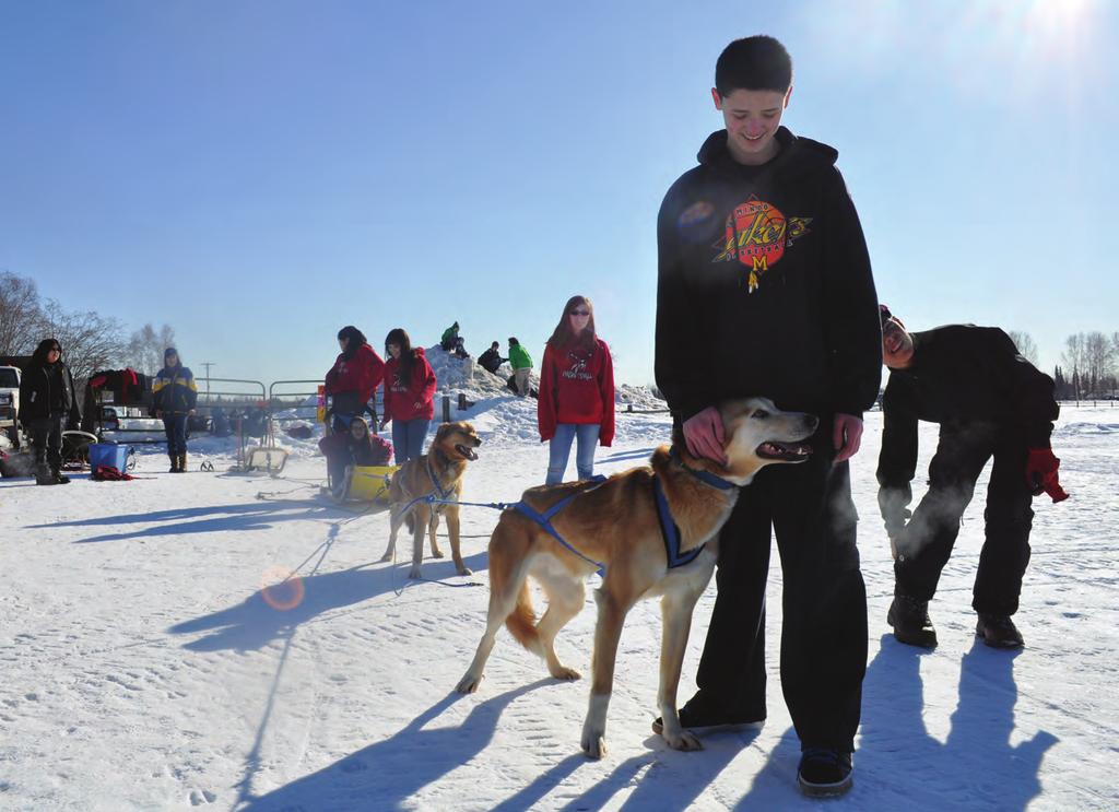 UAF School of Natural Resources and Extension 2014 Youth PROGRAM OFFERS DIVERSE ACTIVITIES Jessy Brockmeyer pets a dog while a member of the 4-H mushing club prepares for dog mushing.