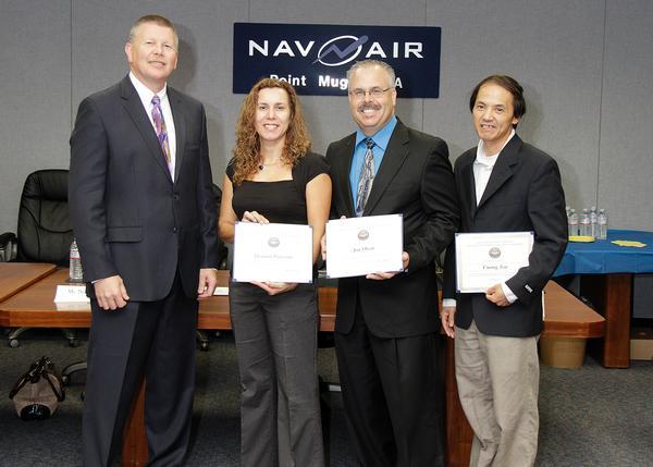 Terry Clark, left, congratulates NAVAIR Leadership Development Program graduate Roberto Garcia in Point Mugu, Calif., Oct. 16 (U.S. Navy photo).
