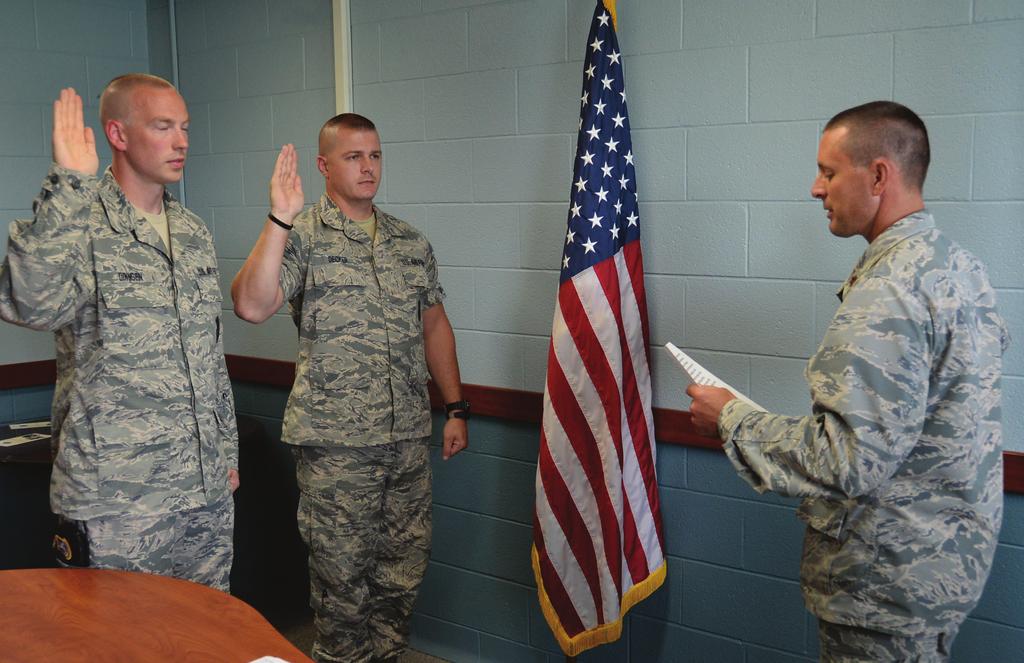 Oath of Enlistment U.S. Air Force Maj. Brain Weitz (right) administers the Oath of Enlistment to Tech. Sgt. Michal Dinnsen (left) and Tech. Sgt. Robert Decker (center) during the August UTA, Aug.