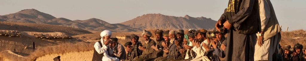 A group of Afghan men face west toward Mecca