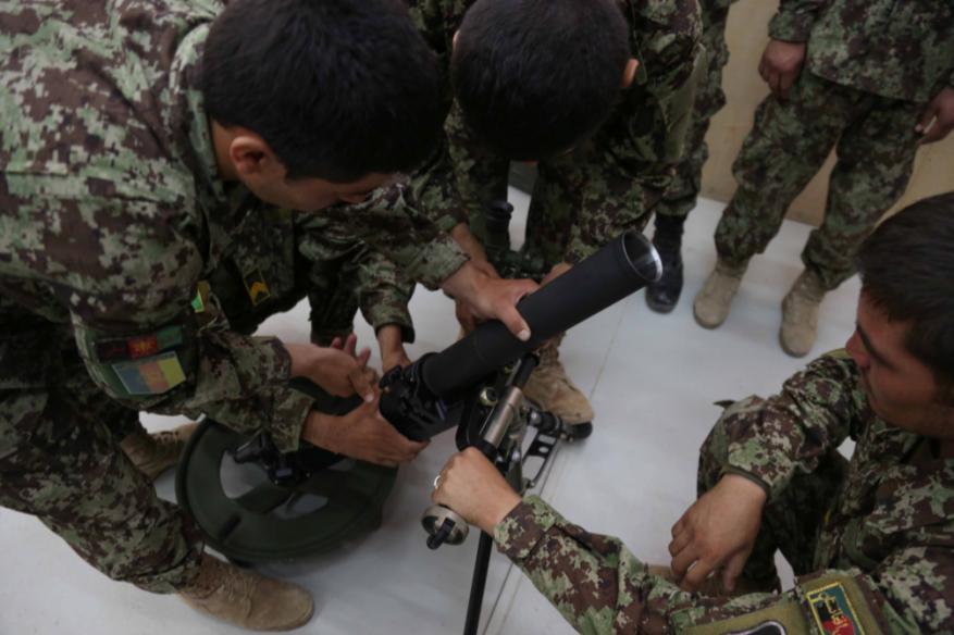 Afghan National Army (ANA) soldiers disassemble a 60mm mortar tube during a simulated mortar training exercise at Forward Operating Base Gamberi, Laghman