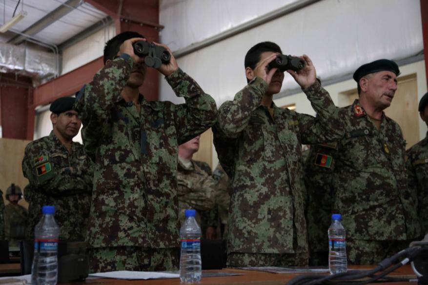Afghan National Army (ANA) soldiers, 201st Corps, look through binoculars for a call for fire exercise during a field artillery instructor graduation ceremony at Forward Operating Base