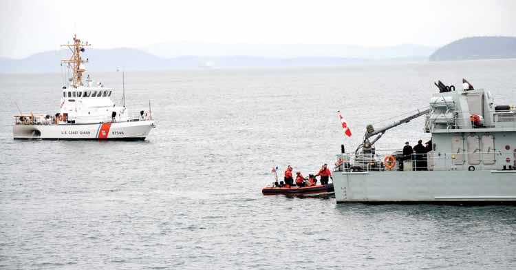 Coast Guard helicopter arrives at HMCS Saskatoon.