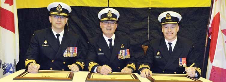 Photo: Cpl Dan Bard Commodore Darren Hawco, left, Rear-Admiral David Gardam, centre, and Captain (Navy) Scott Bishop sign the change-of-command certificates.
