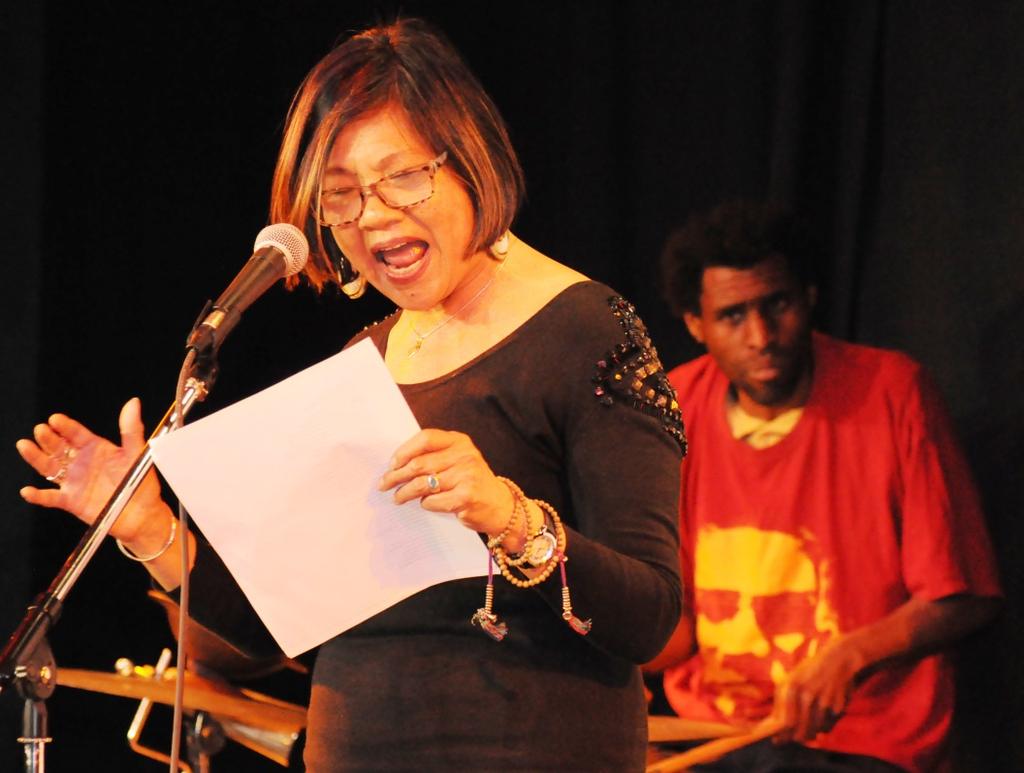 Poet Genny Lim and drummer Marshall Trammell performing at the Black Arts Movement Gala
