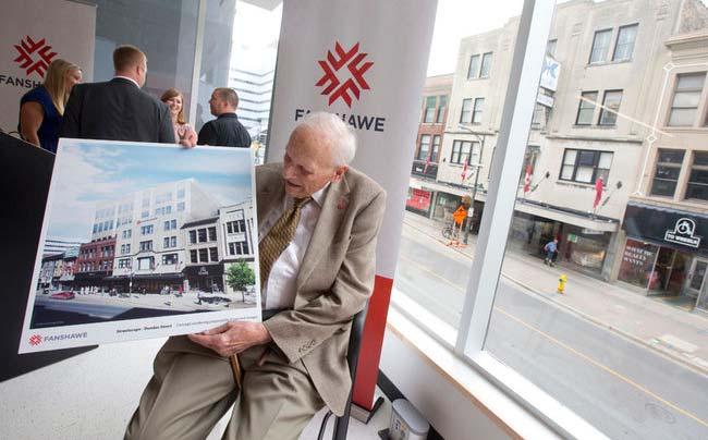 Fred Kingsmill holds an artist rendering that shows Fanshawe College's plan for the Kingsmill's building.