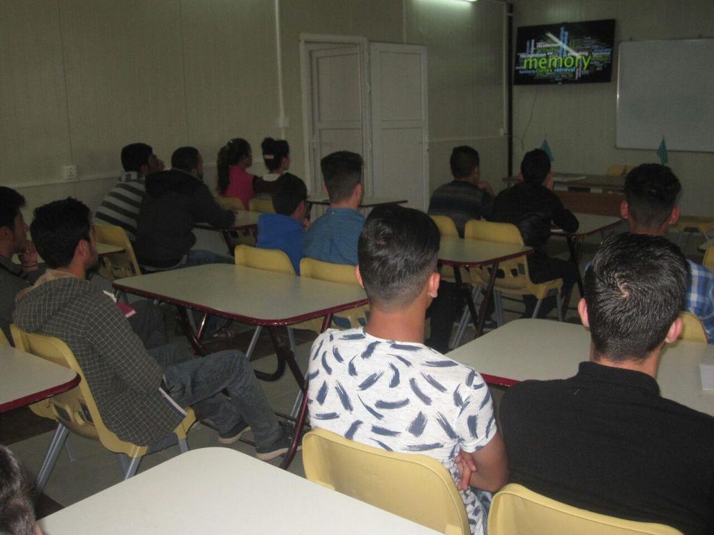 IT trainees watch a video on computer theory in the