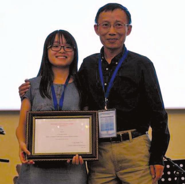 Jie Chen (right), City University of Hong Kong, presents the IEEE CSS Beijing Chapter Young Author Prize to Siyu Xie from the Academy of Mathematics and Systems Science, Chinese Academy of Sciences.
