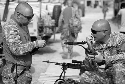 U.S. Army, SSG Adam Mancini SGT Cory Culpepper, right, and SGT Thomas Marstin, Bravo Company, 1st Battalion, 4th Infantry Regiment, U.S. Army Europe, work on communication issues during precombat checks near Forward Operating Base Lane, Zabul, Afghanistan, 11 March 2009, before a humanitarian aid mission near the base.