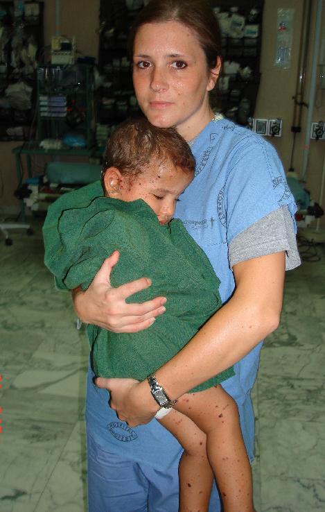 (CSH) holds an Iraqi child.