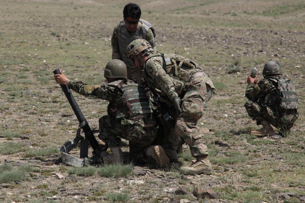 An Afghan National Army soldier from 2nd Khandak, 1st Brigade, 203rd Corps, fires a 60mm mortar round in Khowst province, Afghanistan, June 22, 2013. U.S.