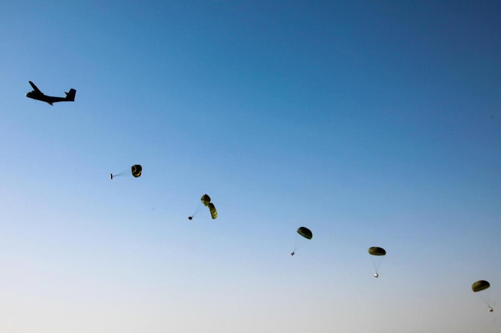 A C-130 Hercules aircraft releases container bundles of supplies during an airdrop on Forward Operating Base Warrior in Ghazni province, Afghanistan, June