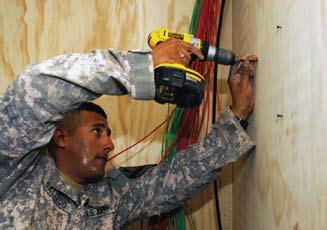 Gallego, a computer systems repairer assigned to C Company, Division Special Troops Battalion, 1st Cavalry Division, helps install fiber optic cables at JSS Ur to upgrade communications capabilities.