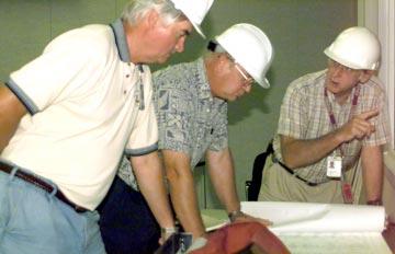 (Photo by Jim Bennett) From left, Phil Backstrom, Ed Black and Ken Barclay go over blueprints for the renovations on the