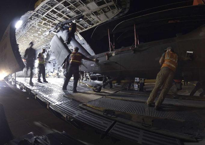 A UH-60 Black Hawk helicopter is unloaded from a C-5M Super Galaxy transport aircraft from Dover Air Force Base, Delaware, on April 8, 2017, at Robert Gray Army Airfield, Texas.