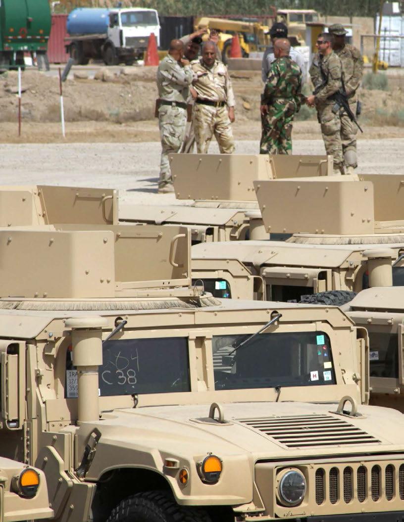 Iraqi security forces receive a shipment of more than 70 up-armored humvees on June 28, 2015, at Camp Taji, Iraq, as part of