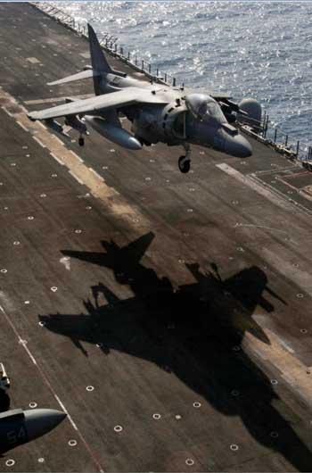 An AV-8B Harrier assigned to Marine Medium Tiltrotor (VMM) 162 (Reinforced) participates in a hover exercise off the flight deck of the amphibious assault ship USS Nassau (Credit photo: USN Visual