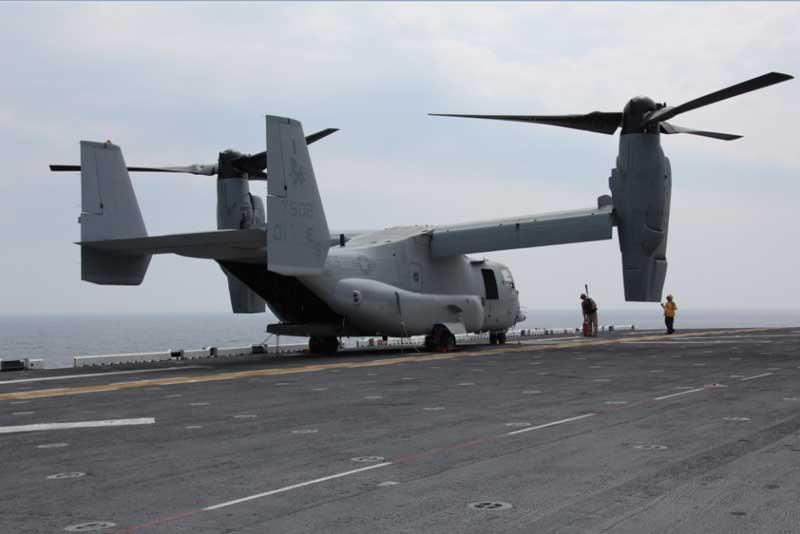 Flight deck crew members prepare an MV-22 Osprey with Marine Medium Tiltrotor Squadron 266, 26th Marine Expeditionary Unit, for take off during flight operations aboard USS Kearsarge, April 23, 2010