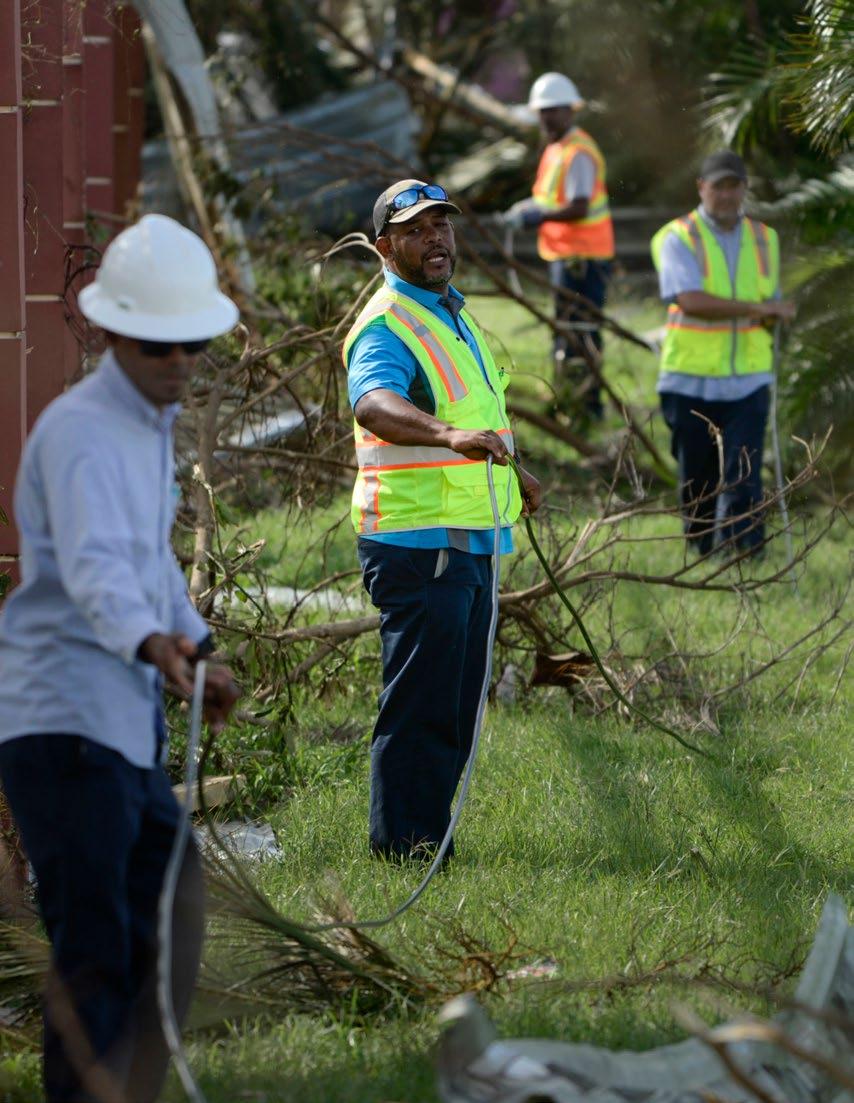 Personnel from Liberty Cable work to restore fiber-optic lines on the third day after the impact of Maria, a Category 4 hurricane that crossed the island, in Carolina, Puerto Rico, Saturday, Sept.