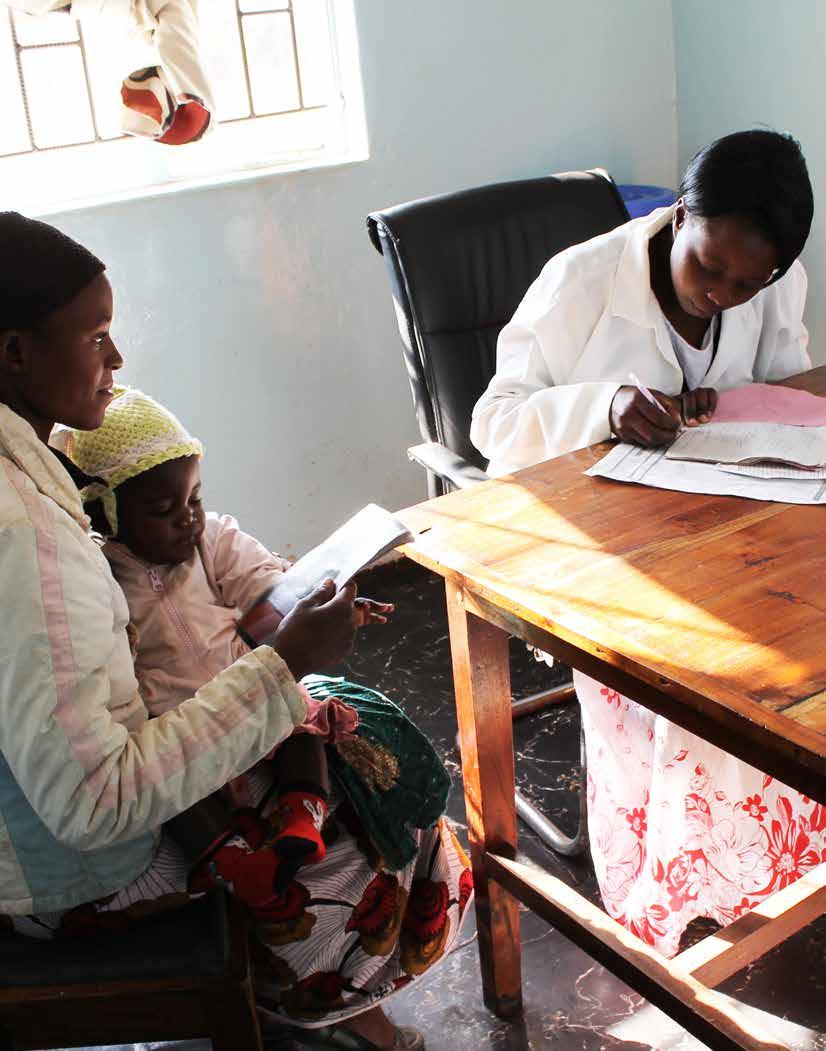A health worker speaks with a mother in
