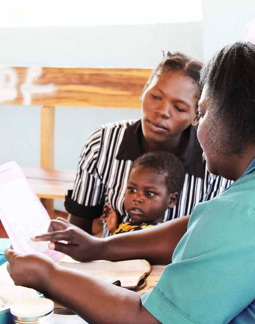 A health worker at Lundazi Urban Clinic in Eastern Zambia reviews vaccination plans with a