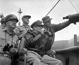 General Douglas MacArthur (seated), commander-in-chief of the United Nations Command and the U.S.