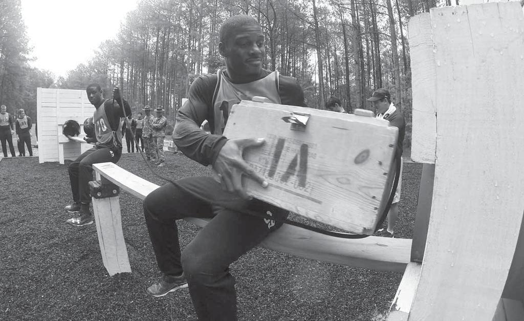 Photos by ROBERT TIMMONS Student-athletes from the University of South Carolina football team, pass ammo crates through an obstacle at the Team Development Course June 21 on Fort Jackson.