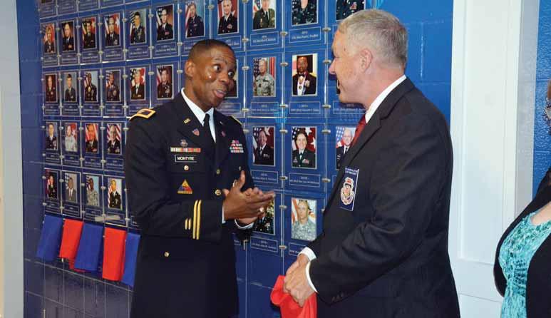 Photos by WALLACE McBRIDE Col. Neal McIntyre, left, commandant of the Adjutant General School, chats with Adjutant General s Corps Hall of Fame inductee Col.