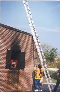 Fan Carry: After advancing the hose line, the applicant will pick up a standard steel exhaust fan weighing approximately 50 pounds, carry it a distance of approximately 30