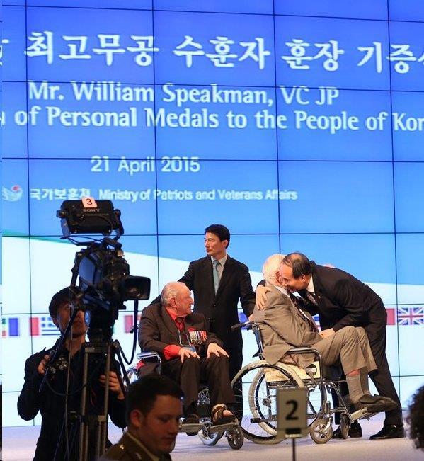 An emotional moment as William Speakman VC turns over his cherished medals to Minister Park Sung Choon who will in turn present them to the War Memorial of Korea for permanent display.