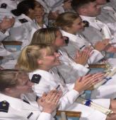 Women (shown here graduation ceremon make up 30% of the Corps of Cadets at t Coast Guard Acade graduate from the C Guard Academy.