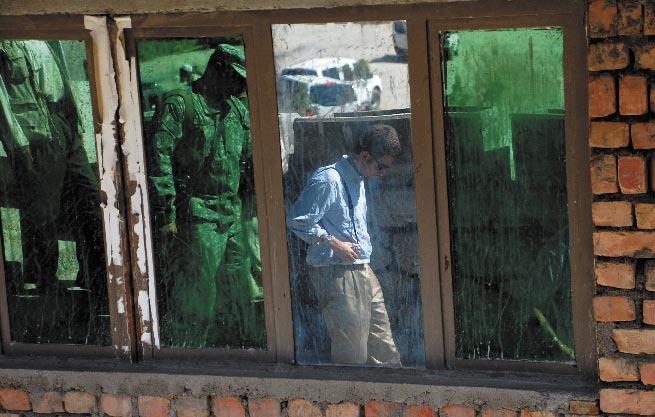 A window leading to Ahmed Shah Massoud s tomb in Panjshir catches the reflection of Alex Tiersky, director of the Defense and Security