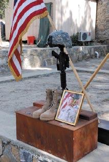 Airlift Squadron from Bagram Airfield. Photo:  Kim Allain/August 2007 A helmet, rifle, ID tags, boots and photo are displayed in memory of Sgt.