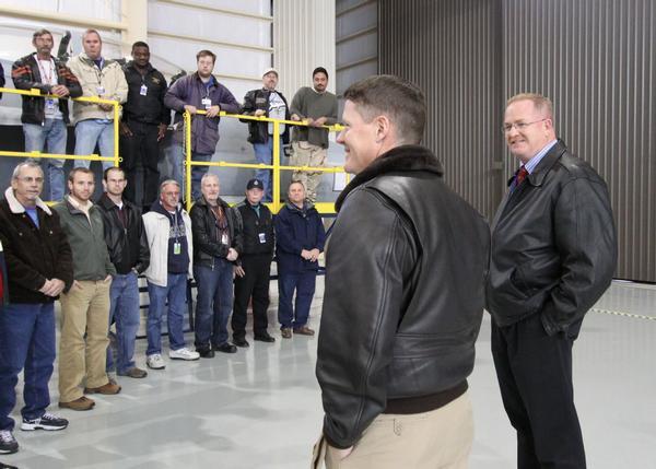 The Fleet Readiness Center Southeast Super Hornet maintenance team, along with representatives from Naval Air Systems Command and Naval Facilities Engineering Command pose in a new maintenance hangar