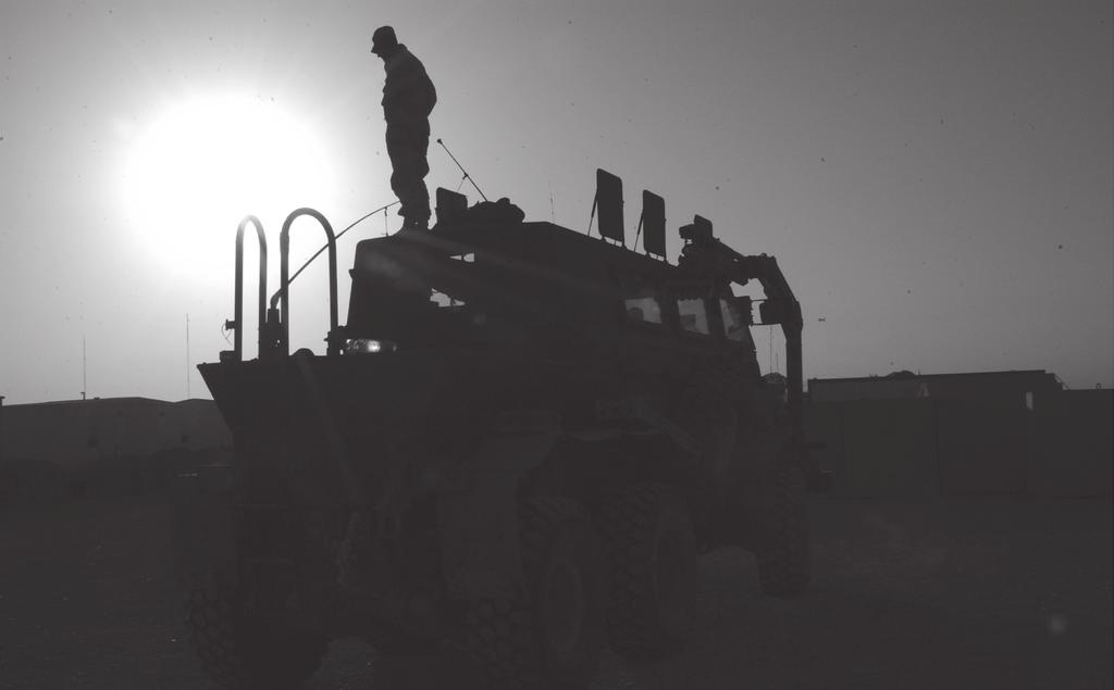 Photo by Colonel Kenneth J. Crawford As the sun sets over Baghdad, a Buffalo crewmember prepares for a night mission.