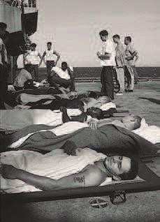 Medical evacuation patients on the deck of the amphibious assault ship USS Tripoli (LPH-10) await transfer to the 22nd Casualty Station in Danang, from which they will be sent to COUS.