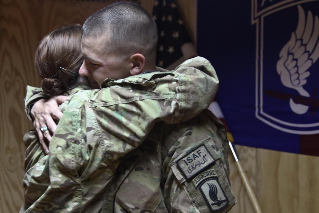 U.S. Army Maj. Donald Lincoln receives a hug from his wife, Capt.