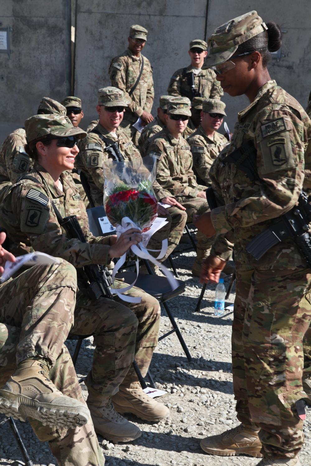 U.S. Army Capt. Lori Lincoln receives a bouquet at her husband's Change of Command ceremony in Forward Operating Base Shank, Oct.