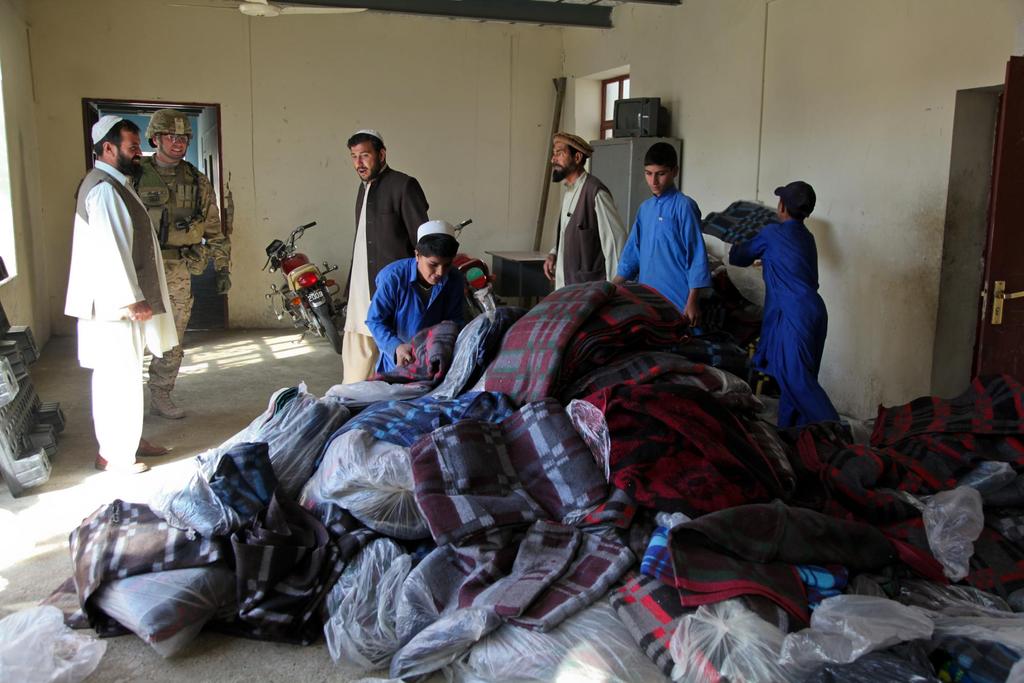 Afghan boys move blankets at the Khost city orphanage, Khost province, Afghanistan, Oct. 22, 2012.
