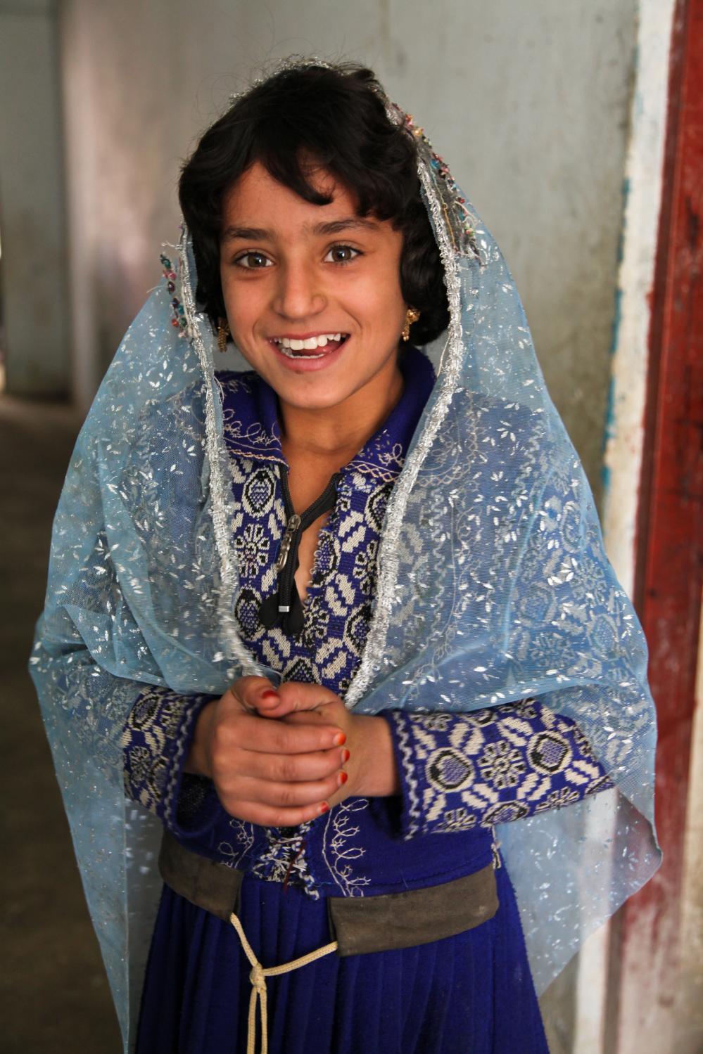 An Afghan girl smiles into the camera at Khost city orphanage, Khost province, Afghanistan, Oct. 22, 2012.