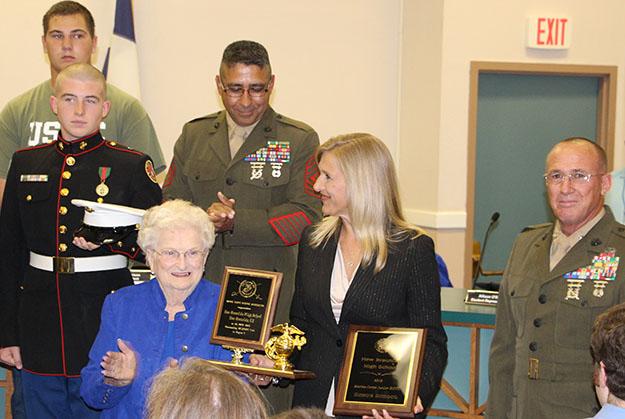 (front, far right) Principal Kara Bock accepts the Marine Corps JROTC awards on behalf of