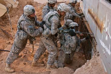 Combat engineers from 3rd Platoon, 573rd Clearance Company, 1st Engineer Battalion, out of White Sands Missile Range, N.M., work in the dark Iraq heat.