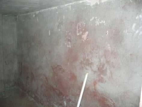 Figure 3 Site Photograph of Weapons Storage and a Torture Chamber Weapons cache found in a local mosque, November 2004. Blood stained walls of a torture chamber, November 2004.